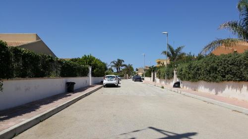 a white car parked on the side of a street at A Due Passi Dal Mare in Petrosino
