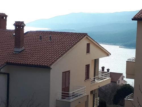 a house with a view of the water at Apartment Calista in Rabac