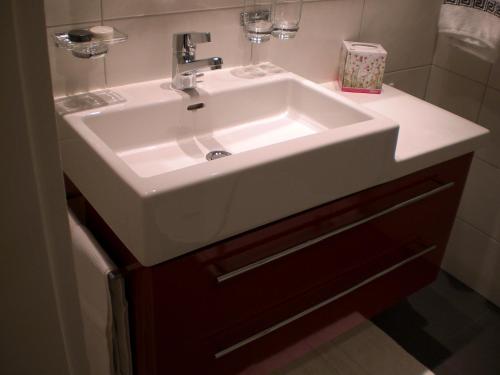 a bathroom with a white sink in a bathroom at Studio Carlton am Park in Davos