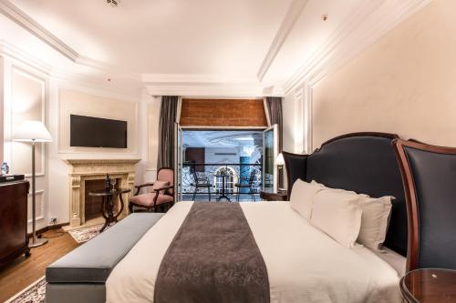 a hotel room with a bed and a fireplace at Xheko Imperial Luxury Hotel & SPA in Tirana