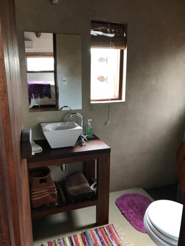 a bathroom with a sink and a mirror at Las Chasconas Cabañas Boutique in Punta Del Diablo