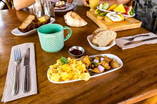 a table with plates of breakfast food on it at Hotel Cantarana in Playa Grande