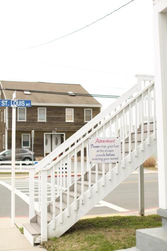 a white staircase with a sign in front of a building at Lukas Apartments in Ocean City