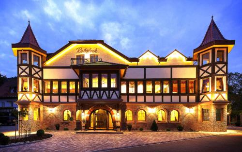 a large brick building with lights on it at Hotel Rebstock in Baden-Baden