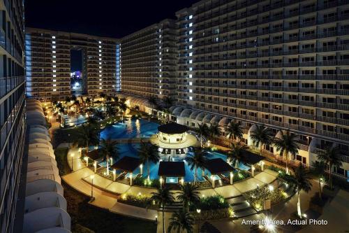 an overhead view of a hotel swimming pool at night at Shell Residences in Manila