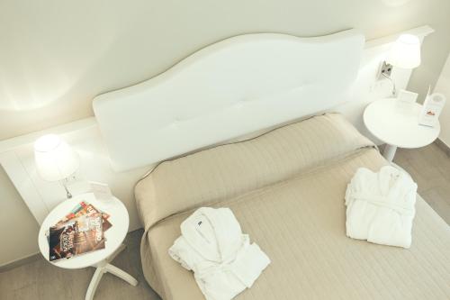 - une chambre avec un lit et une table avec des serviettes dans l'établissement Scala Dei Turchi Resort, à Realmonte