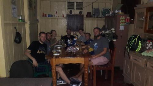 a group of people sitting around a table at Zazil Ha Hostel in El Remate