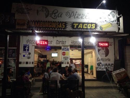 a group of people sitting at a restaurant at night at Hotel Chaac Calakmul in Xpujil