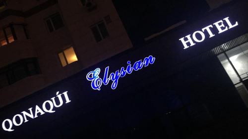 a neon sign on the side of a hotel at Elysian hotel in Astana