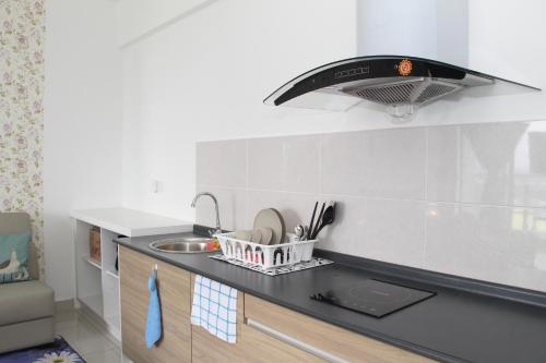 a kitchen with a sink and a light above a counter at Comfort Zone Premium Guesthouse @ Evo Bangi in Bangi