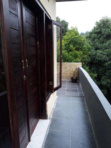 an open door of a house with a walkway at Sugi Gede Homestay in Singaraja
