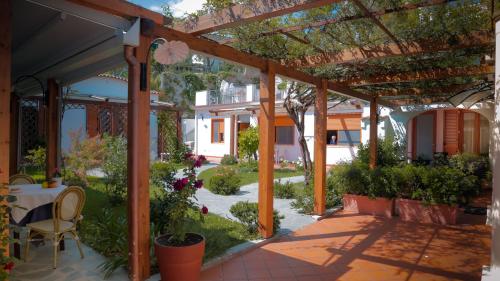 a patio with a table and chairs under a pergola at Casa Vacanze Vittoria in Ravello