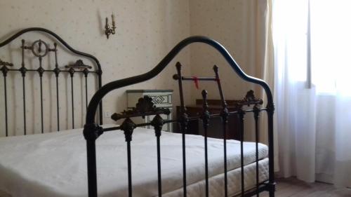 a bedroom with a black bed with white sheets and a window at Terraube Ter in Terraube