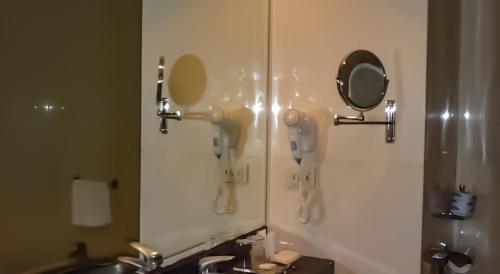 a bathroom with two hair dryers and a mirror at Hotel Il Maglio in Imola