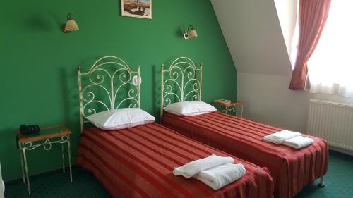 Un pat sau paturi într-o cameră la Hotel Melody