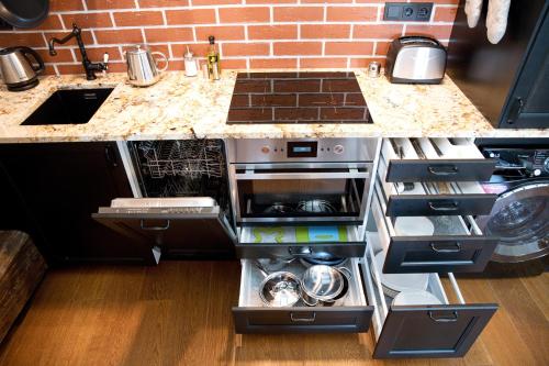 a kitchen with a counter with a sink and a stove at Bed&Bike Prachatice in Prachatice