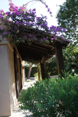a pergola with purple flowers on top of a building at Villa Bruyere in Antibes