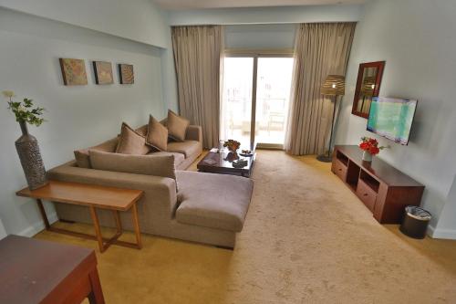 a living room with a couch and a table at Tolip Family Park Hotel in Cairo