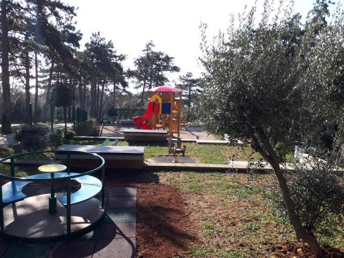 a park with a playground with a table and a bench at Apartment Calista in Rabac