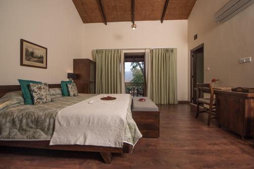 a bedroom with a bed with a table and a sink at Fateh's Retreat, Homestay in Sawāi Mādhopur