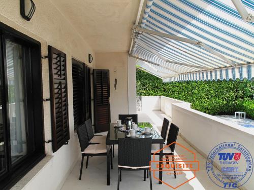 a patio with a table and chairs on a balcony at Villa Kovach in Krk