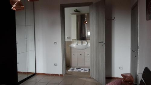 a bathroom with a sink and a mirror at B&B Pierilu' in Grosseto