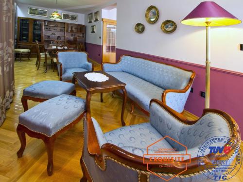 a waiting room with blue chairs and a table at Villa Kovach in Krk