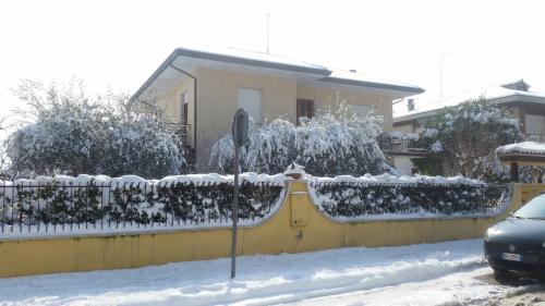 a house with a fence covered in snow at A Casa Di Gabri in San Giovanni in Marignano