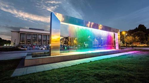 a building with colorful lights on the side of it at Ruta 80 Hostel in Brno