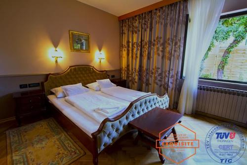 a bedroom with a bed and a table and a window at Villa Kovach in Krk