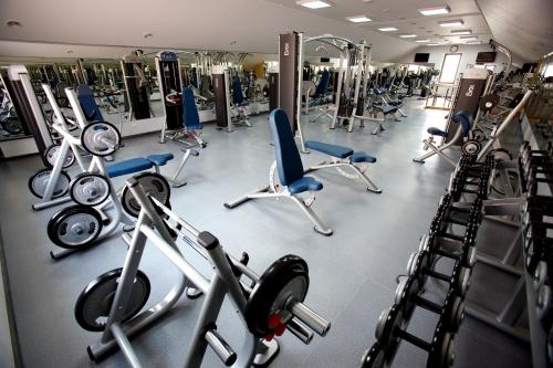 a gym filled with lots of exercise equipment at CityClub Hotel in Tiraspol