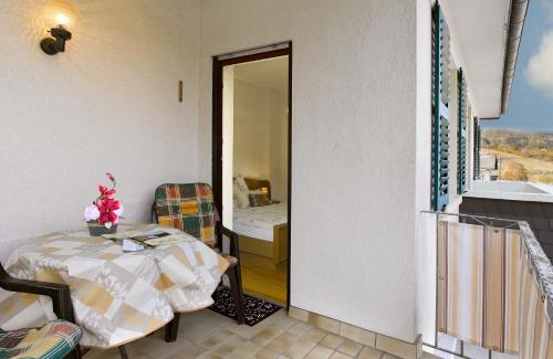 a balcony with a table and a view of a room at Pension "Haus am Walde" Brodenbach, Mosel in Brodenbach
