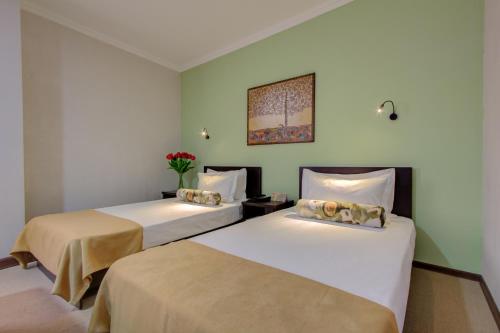 Кровать или кровати в номере Olive Hotel Bishkek