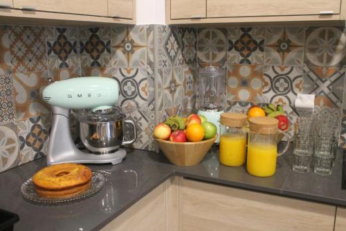 a kitchen counter with a mixer and a bowl of fruit at H18 in Horta