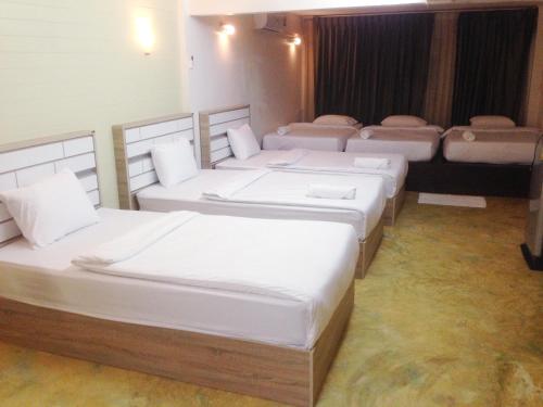 a group of four beds in a room at is boutique huahin hotel in Hua Hin