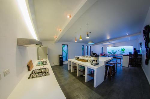 a kitchen with a white island in a room at Palaka Resort in General Luna