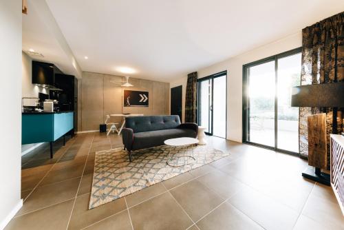 a living room with a couch and a table at Citta di Lume Suites & Lofts in Porto-Vecchio