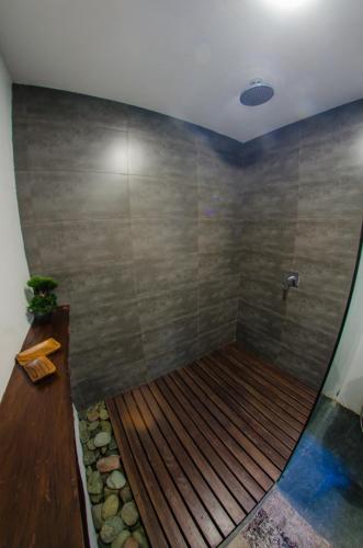 a bath tub with a wooden floor in a bathroom at Palaka Resort in General Luna