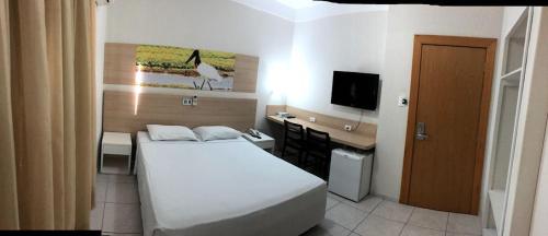 Ένα ή περισσότερα κρεβάτια σε δωμάτιο στο Hotel Veneza