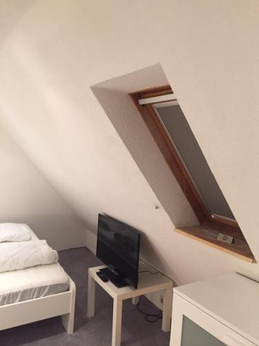 a room with a bed and a tv in a attic at Heaven in Winterberg