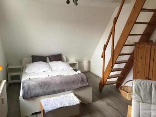a bedroom with a bed and a stair case at Heaven in Winterberg