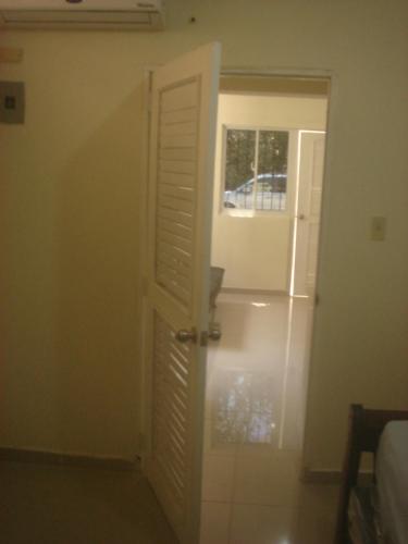 a door leading to a room with a window at Dre Broeders Apartments Juan Dolio in Juan Dolio