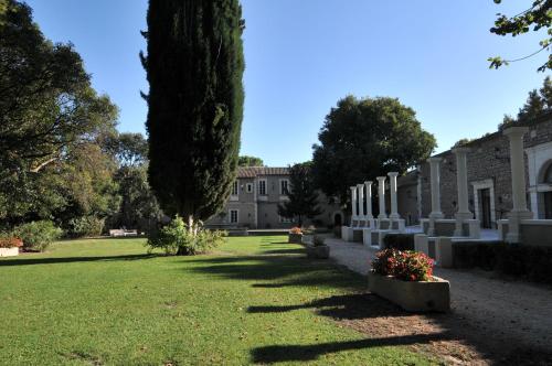 a large building with trees and a grass yard at Domaine du Grand Malherbes in Aimargues