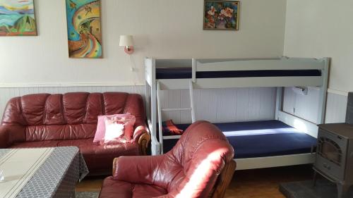 a living room with a couch and a bunk bed at Milas House two apartments in Fredvang