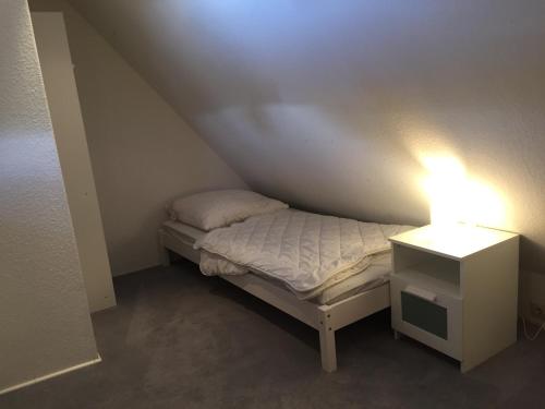 a small bed in a small room with a lamp at Heaven in Winterberg