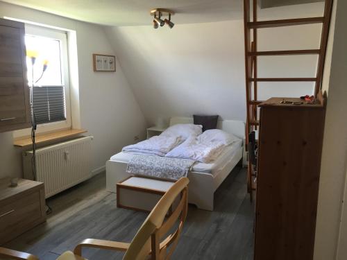 a small bedroom with a bed and a ladder at Heaven in Winterberg