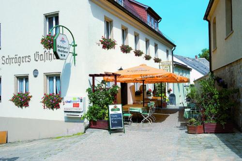 an orange umbrella sitting outside of a building at Pension Schrägers in Königstein an der Elbe