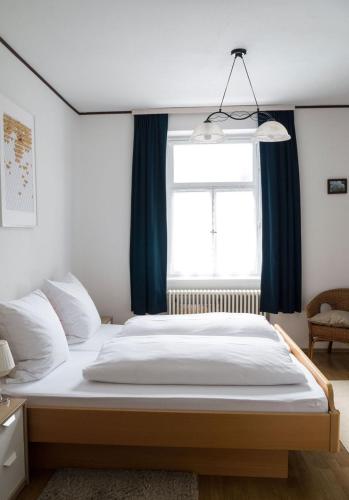 a bedroom with a large bed with a window at Hotel B&B Steinasäge in Bonndorf im Schwarzwald