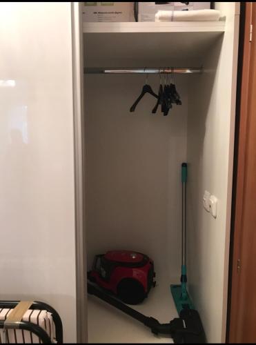 a closet with a red suitcase and a mop at Vigo Luxe Apartment in Nesebar