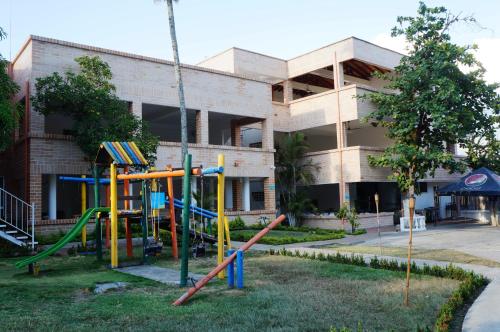 a playground in front of a building at Hostería Fundadores in Santa Fe de Antioquia